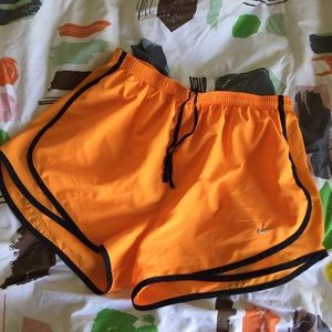 Bright orange Nike dry fit running shorts